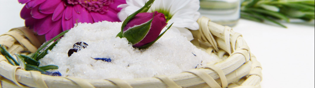 Ein Salz- oder Zuckerpeeling bringt zusätzliche Pflege für die Haut.