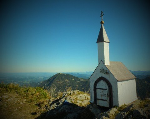 The miniature church holds the summit book.