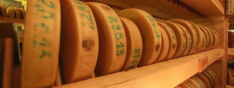 The cheese wheels are placed on several floors and are artfully illuminated.