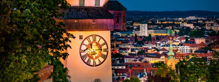 The clock tower is illuminated at night.