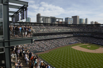 A Rockies game at Coors Field. The seats in the upper deck's 20th row are purple to mark the elevation of one mile, while all other seats in Coors Field are dark green.