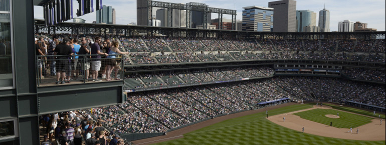 A Rockies game at Coors Field. The seats in the upper deck's 20th row are purple to mark the elevation of one mile, while all other seats in Coors Field are dark green.