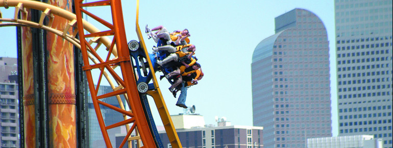 The half pipe roller coaster at Elitch's with the Denver skyline in the background.