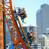 The half pipe roller coaster at Elitch's with the Denver skyline in the background.