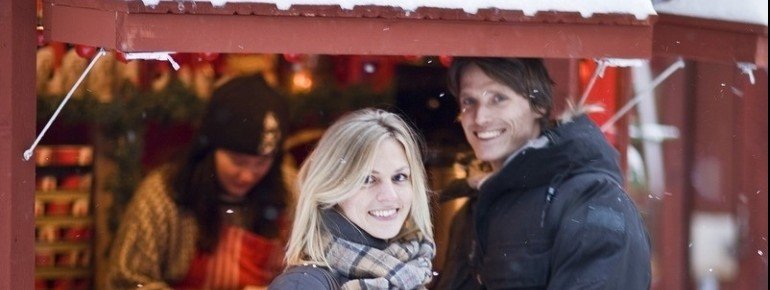 A couple enjoying their time at the snowy Gamla Stan Christmas Market
