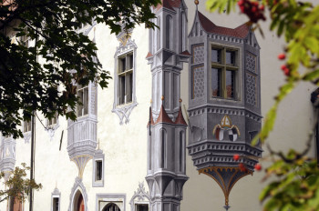 Illusionistic murals decorate the courtyard façades.