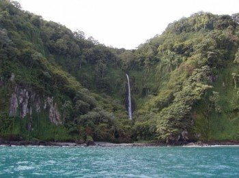 Numerous waterfalls topple from steep cliffs into the sea