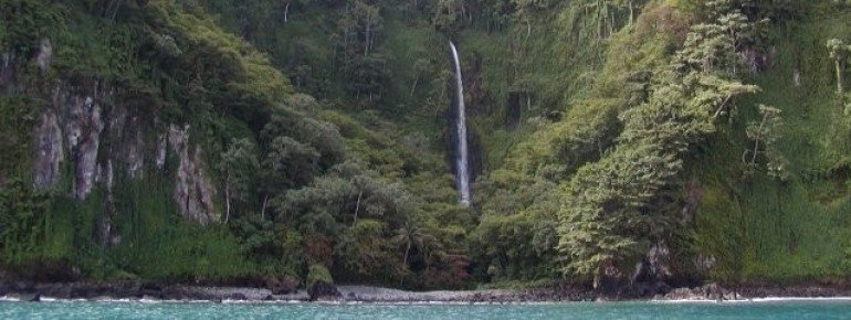 Numerous waterfalls topple from steep cliffs into the sea