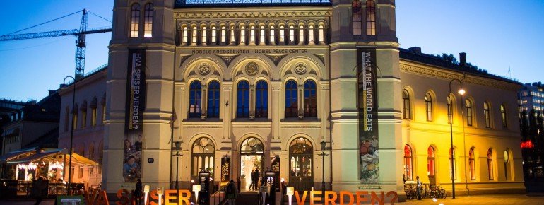 The lit up Nobel Peace Center at dusk