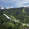 The Olympic ski jump hill infront of its alpine backdrop.