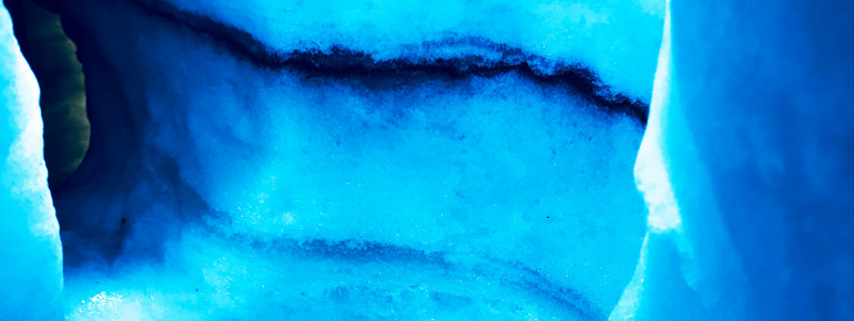 The dark stripes in the ice show you exactly how Iceland's glaciers are characterized by steady volcanic eruptions.