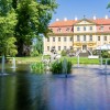 The expansive palace park invites visitors to stroll and linger in a baroque setting.