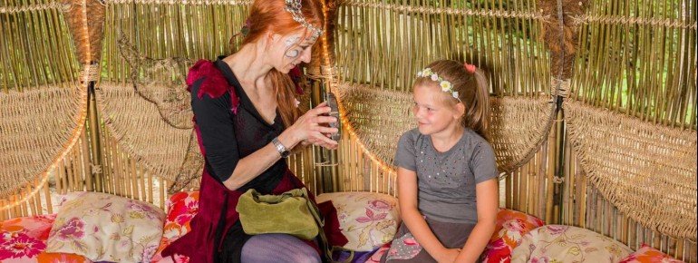 The fairy enchants the little visitors in her willow dome