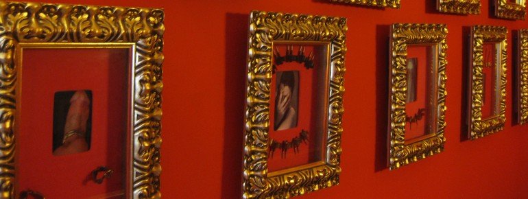 Body decoration and piercings are displayed in picture frames along the hallways.