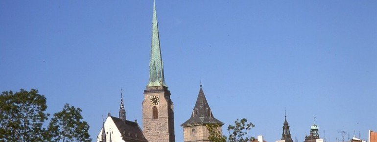 The tower of the cathedral over the rooftops of the city