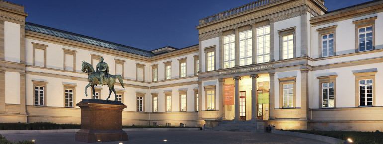 The historic museum building by night.