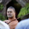 Maori guard standing at the entrance of the village