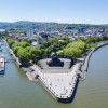 The panoramic image shows the confluence of the Rhine and Moselle rivers at the Deutsches Eck.