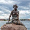The Little Mermaid on the reddish stone at Copenhagen&#39;s port entrance