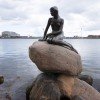 The Little Mermaid in front of Copenhagen&#39;s port scenery
