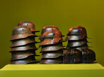 Installation with steal helmets at the exhibition.