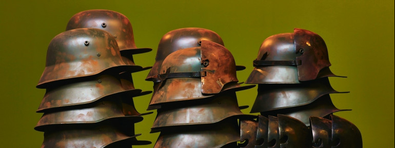 Installation with steal helmets at the exhibition.
