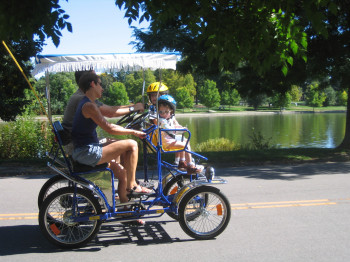 Family rides in a bicycle cart at Washington Park.