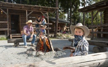 Camping with the whole family in one of the authentic log cabins.