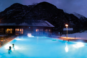 The outdoor pool by night at Premia Spa